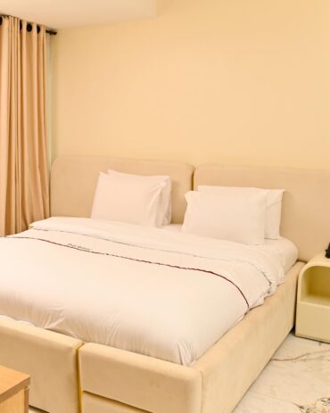 The master suite in our Premium Serviced Short Let Apartments featuring a king-sized bed.